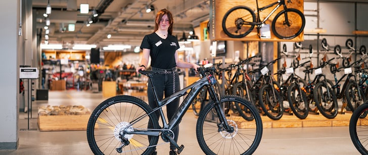 Bike World Verkäuferin präsentiert ein TREK Mountainbike