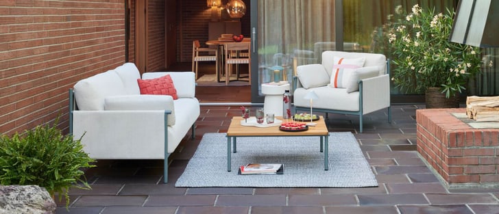 Terrasse confortable avec des canapés blancs, table en bois et décorations pour une soirée détendue.