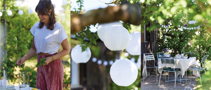 Decorazione estiva da giardino con luci decorative, lanterne di carta e tavolo apparecchiato.