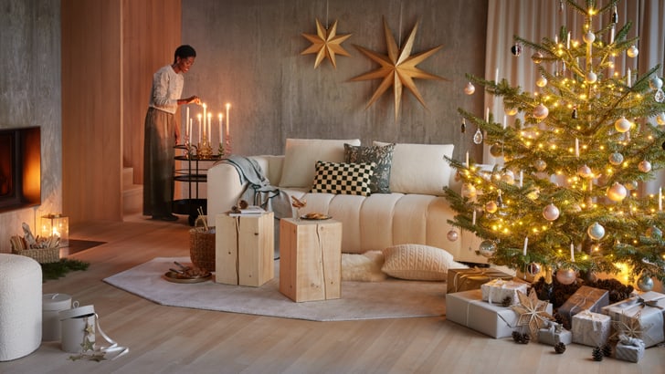 Un soggiorno decorato per Natale con un albero illuminato e regali.