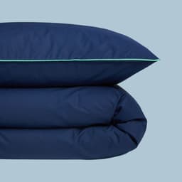Oreiller et couette bleu foncé avec bordure verte de la collection.