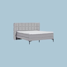 Lit boxspring élégant en gris avec tête de lit rembourrée.